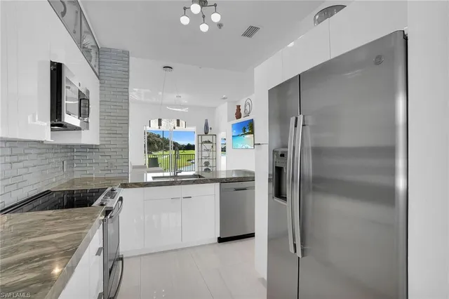 a kitchen with a refrigerator and a sink
