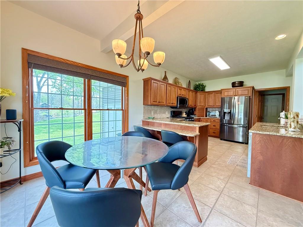 334 Manito Trail Mercer, PA 16137 - Photo 13 of 49 a dining room with wooden floor a chandelier a wooden table and chairs