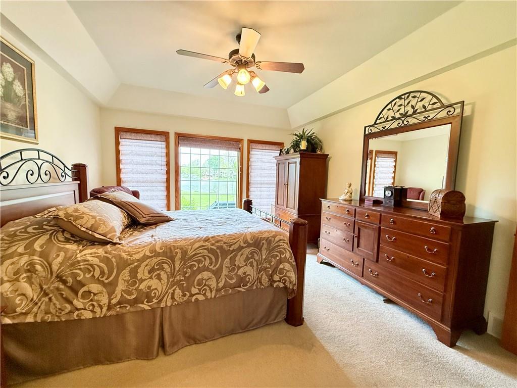 334 Manito Trail Mercer, PA 16137 - Photo 17 of 49 a spacious bedroom with a large bed and a chandelier