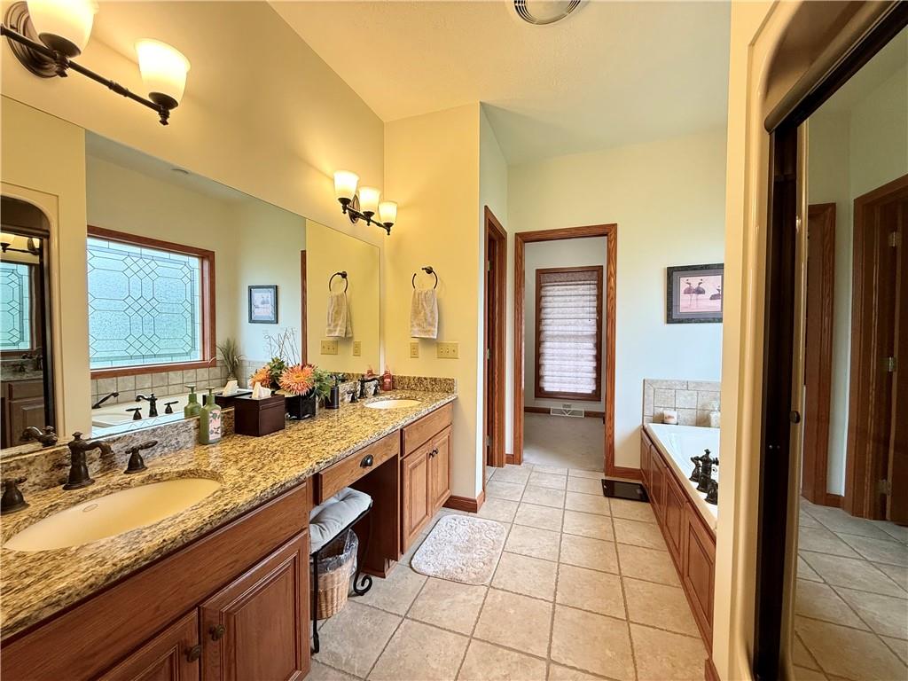 334 Manito Trail Mercer, PA 16137 - Photo 18 of 49 a bathroom with a granite countertop sink mirror and a bathtub