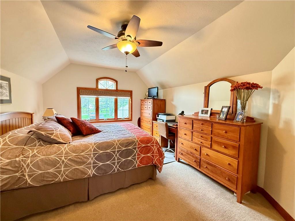 334 Manito Trail Mercer, PA 16137 - Photo 25 of 49 a bedroom with a bed and a chandelier