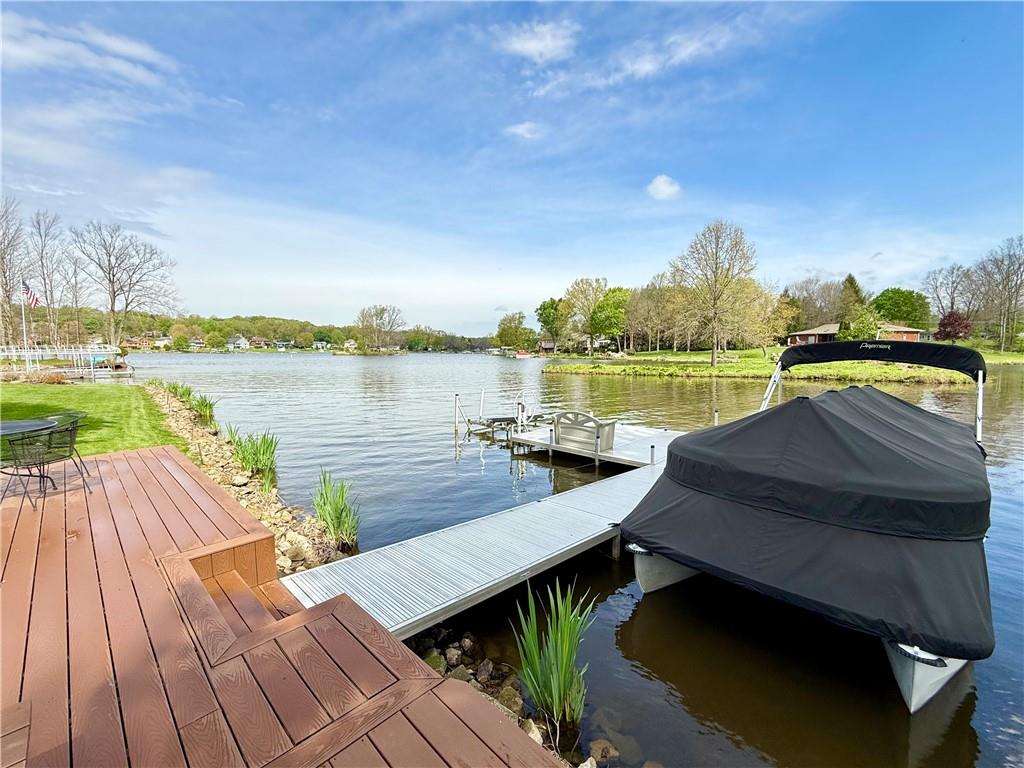 334 Manito Trail Mercer, PA 16137 - Photo 48 of 49 a view of a lake from a balcony with wooden floor and lake view