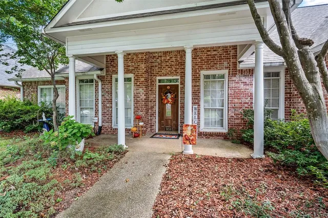 front view of a brick house with a large windows