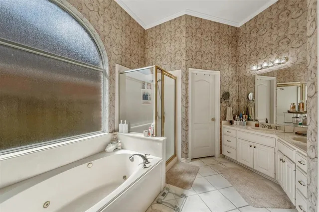 a bathroom with a bathtub sink mirror and shower