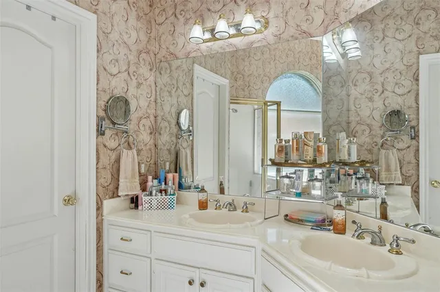 a bathroom with a double vanity sink mirror and