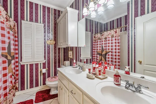 a bathroom with a sink double vanity and a shower curtain