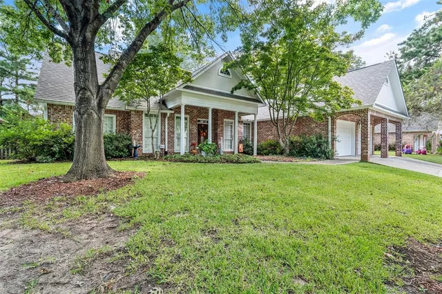 a front view of house with yard and green space