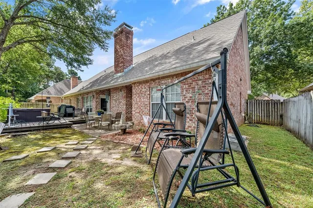 a view of swimming pool with lawn chairs and plants