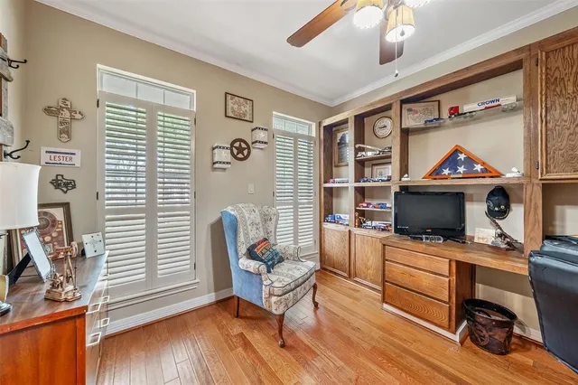 a view of a workspace with furniture and a window