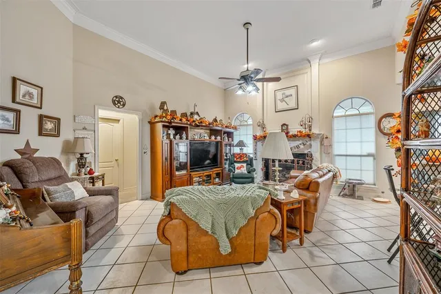 a living room with furniture a flat screen tv and kitchen view
