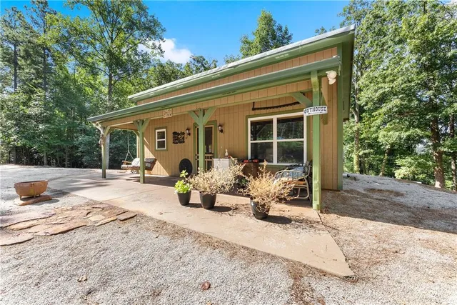 a front view of a house with sitting area and garden
