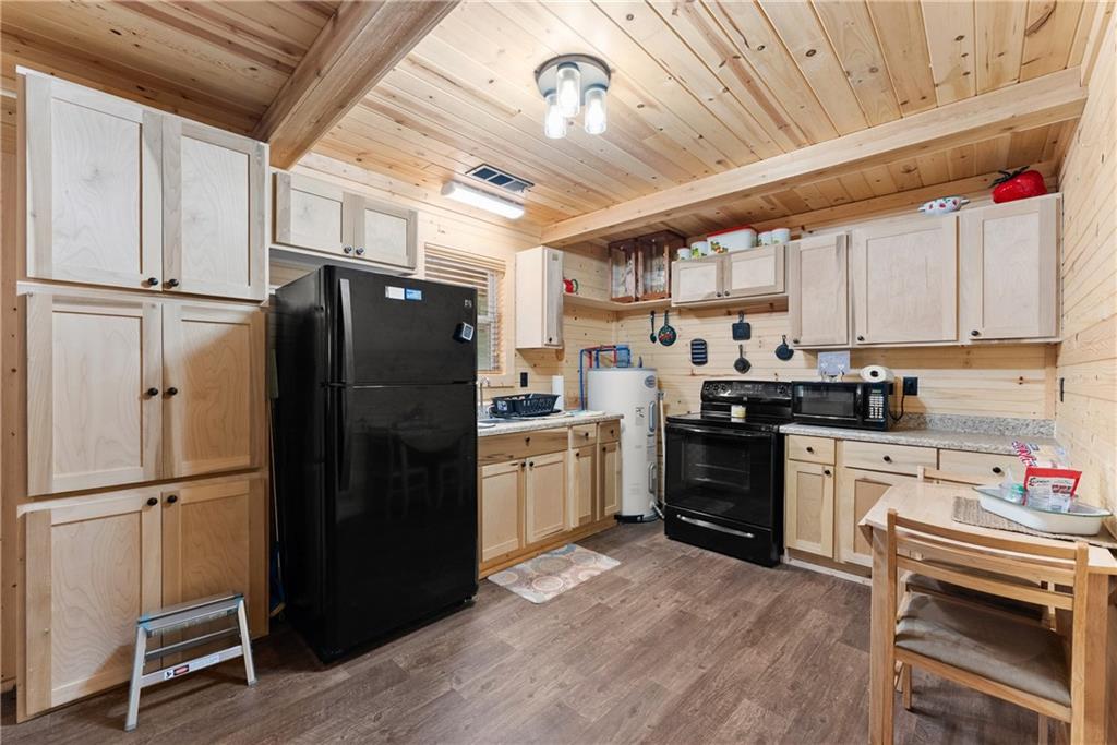318 Jim Grizzle Road Royston, GA 30662 - Photo 13 of 56 a kitchen with granite countertop a refrigerator stove top oven and sink