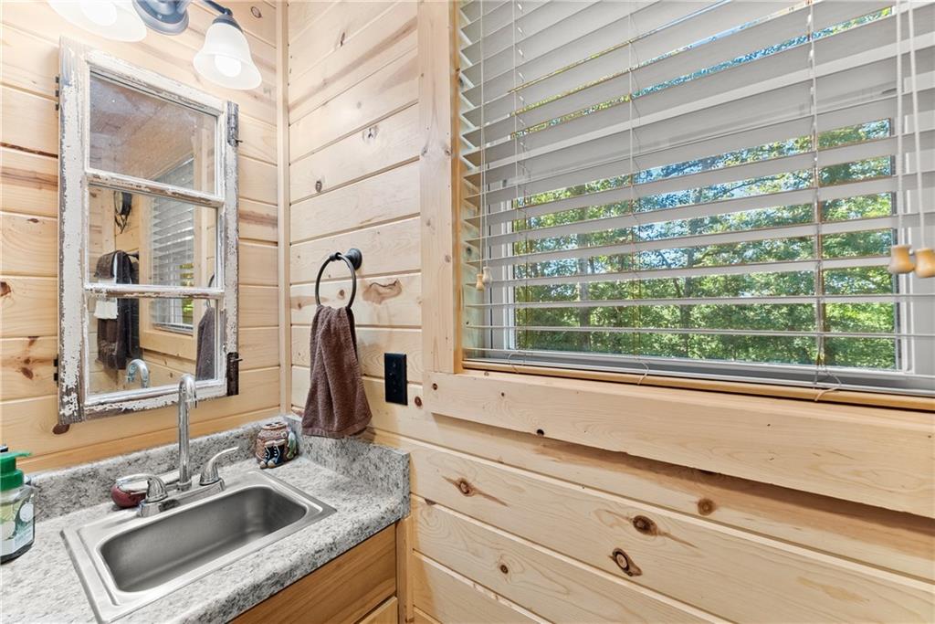 318 Jim Grizzle Road Royston, GA 30662 - Photo 14 of 56 a bathroom with a sink and a window