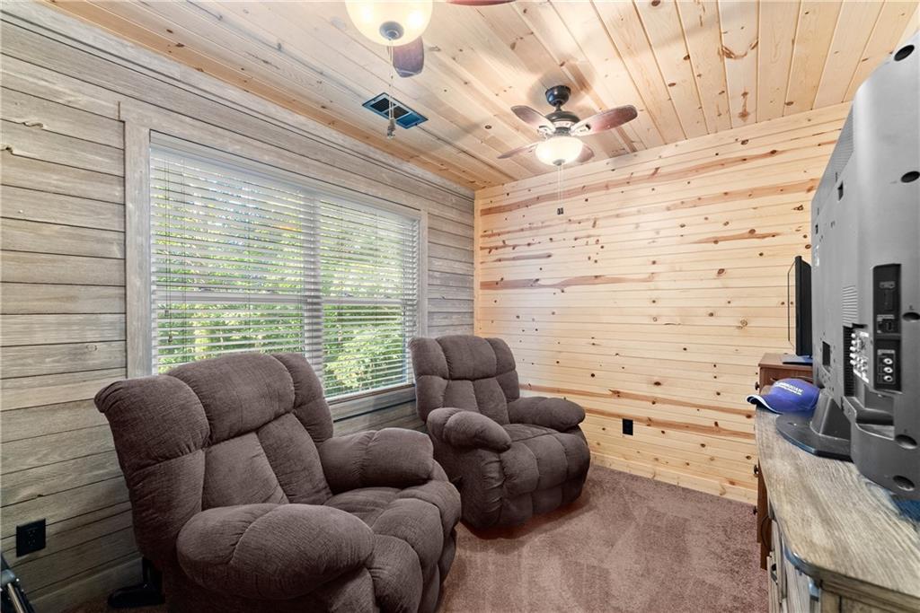 318 Jim Grizzle Road Royston, GA 30662 - Photo 17 of 56 a living room with furniture wooden floor and a large window