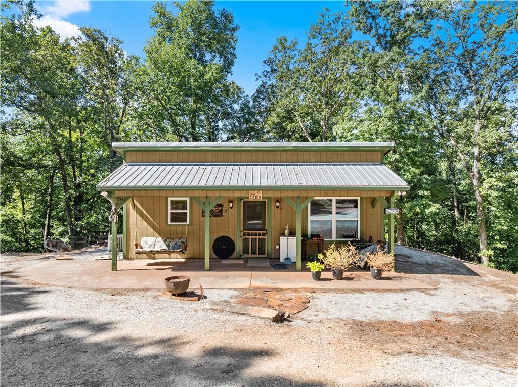 318 Jim Grizzle Road Royston, GA 30662 - Photo 4 of 56 a view of a patio with table and chairs under an umbrella