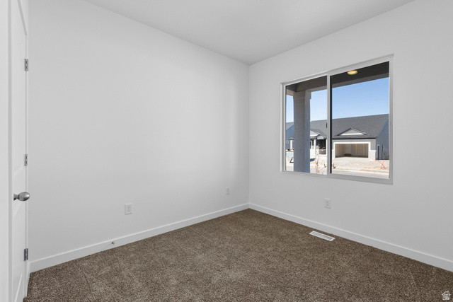 2823 North 710 West, Unit 16 Logan, UT 84321 - Photo 5 of 22 Spare room featuring baseboards and dark carpet