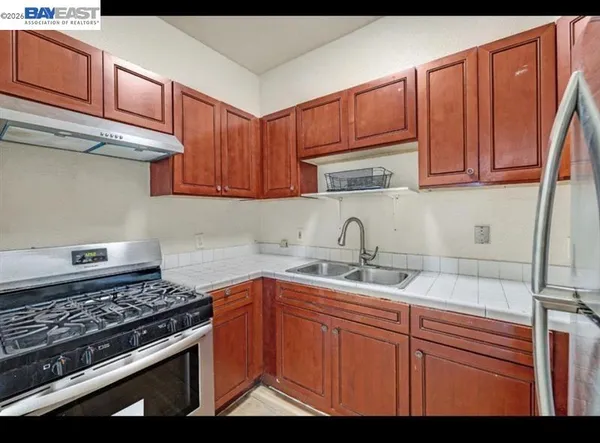 a kitchen with stainless steel appliances granite countertop a sink stove and cabinets