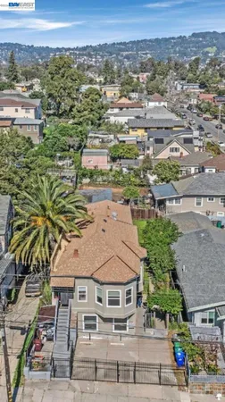 an aerial view of residential houses with outdoor space and trees