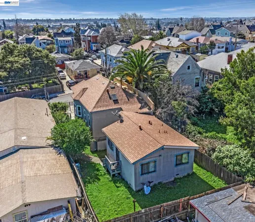 an aerial view of a house with a yard big trees