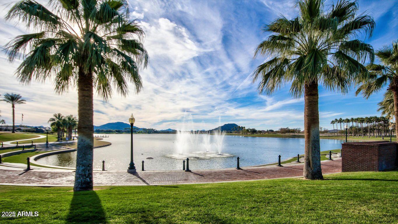 8564 San Filipe Drive, Unit 4 Goodyear, AZ 85338 - Photo 14 of 15 a view of a lake and a garden