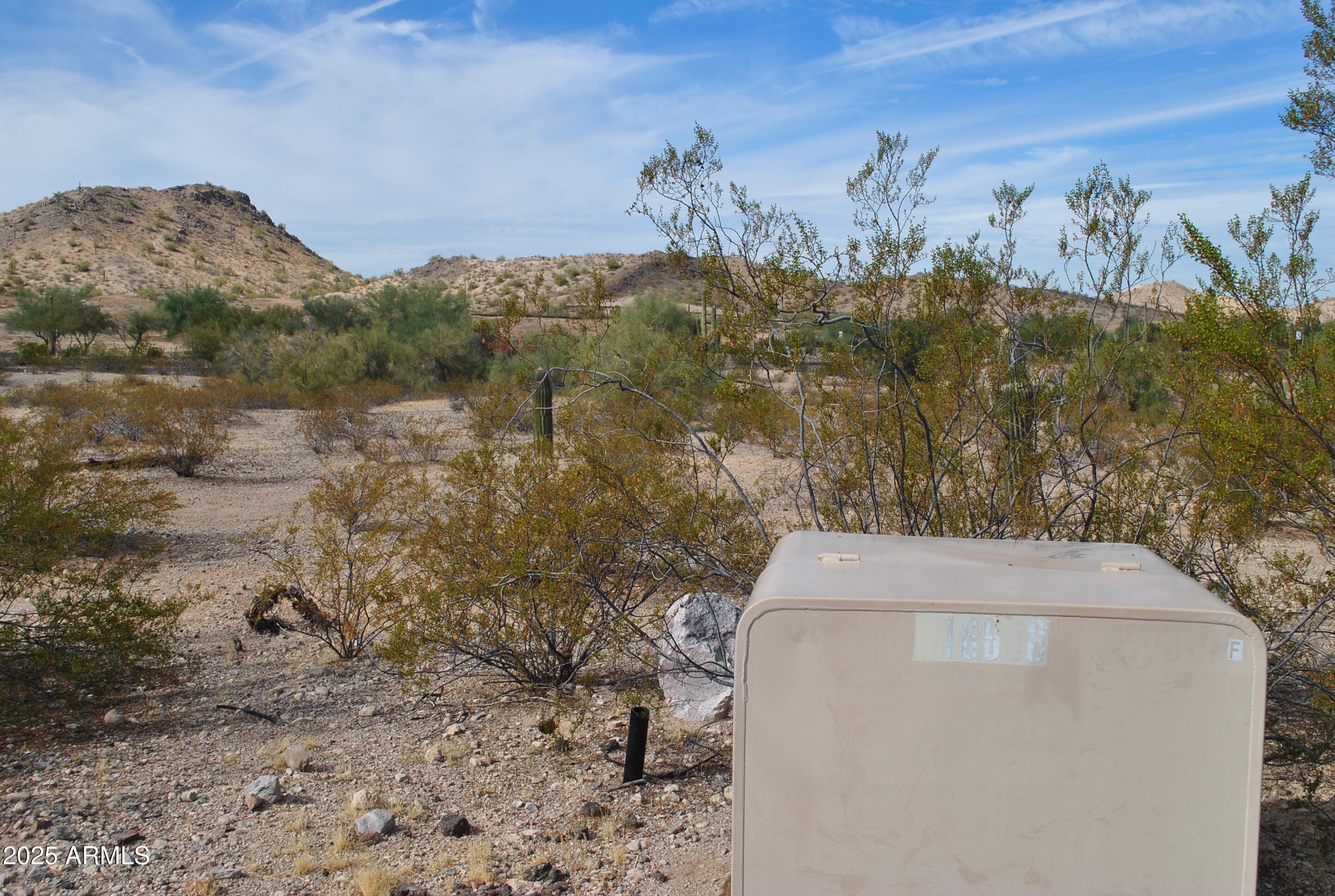 8564 San Filipe Drive, Unit 4 Goodyear, AZ 85338 - Photo 2 of 15 a view of a dry yard with mountains in the background