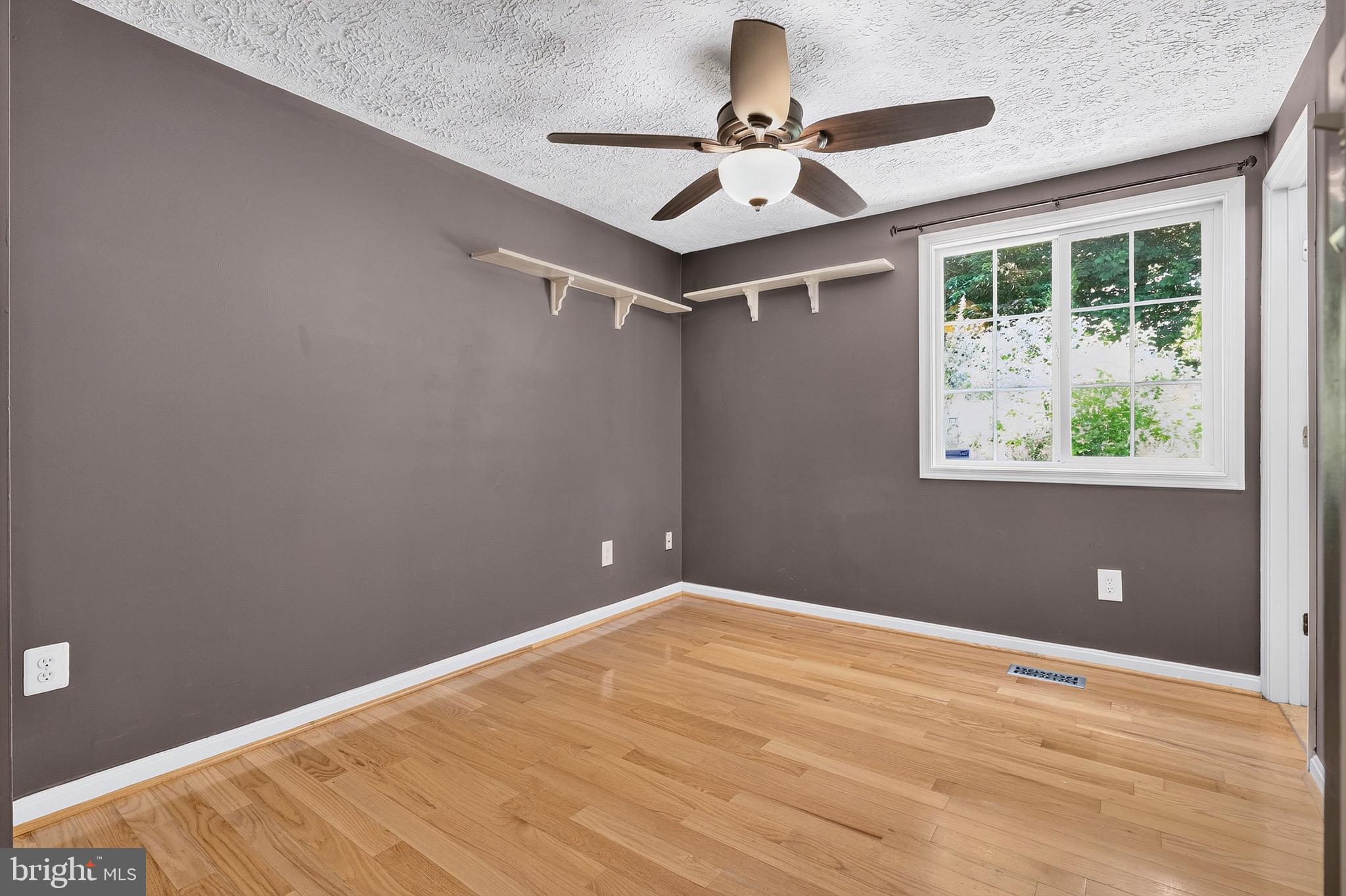 8471 Great Lake Lane Springfield, VA 22153 - Photo 18 of 65 a view of a big room with wooden floor and windows