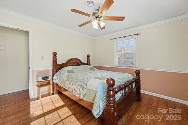 a bedroom with a bed and a ceiling fan