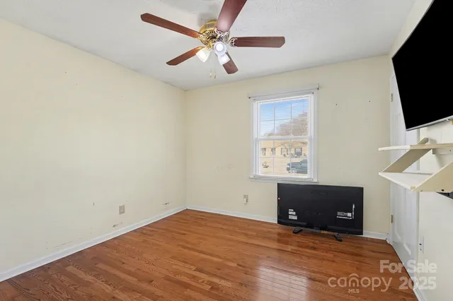 a view of room with window and a ceiling fan