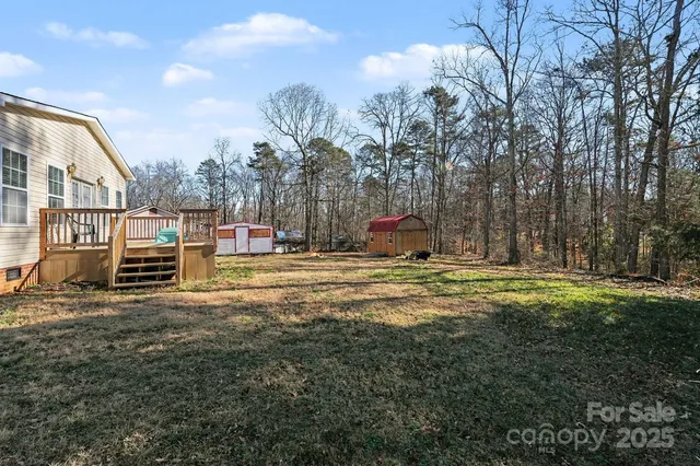 a swimming pool with outdoor seating and yard