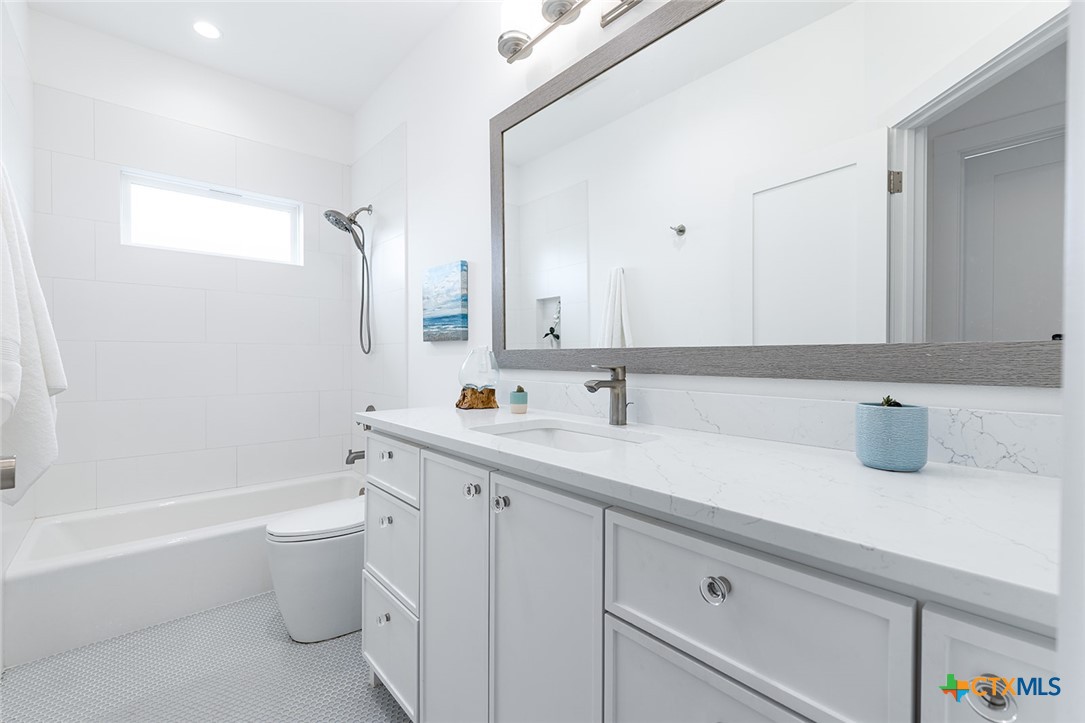 477 Willow Moon Ranch Road Crawford, TX 76638 - Photo 28 of 40 a bathroom with a sink double vanity and toilet