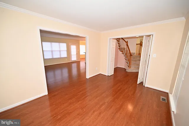 a view of a livingroom with wooden floor and a fireplace