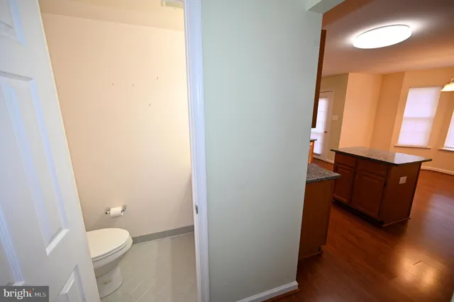 a kitchen with stainless steel appliances granite countertop a sink stove and wooden floor