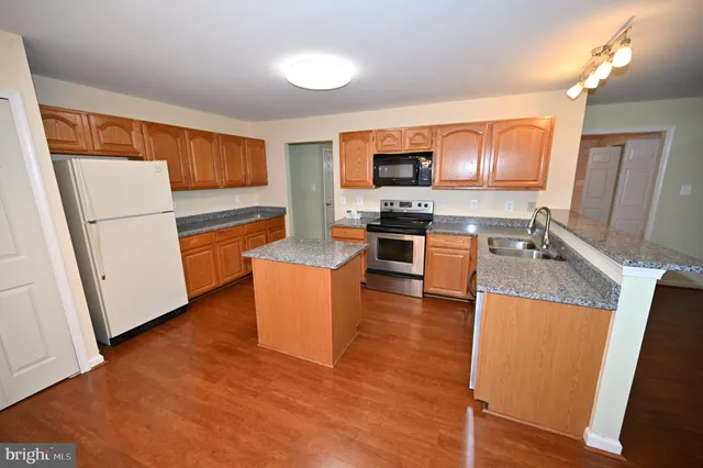 a kitchen with a sink appliances and cabinets