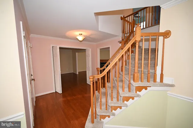 a view of a room with wooden floor and staircase