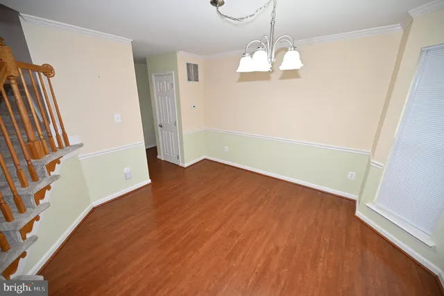 a view of an empty room with a window and fireplace