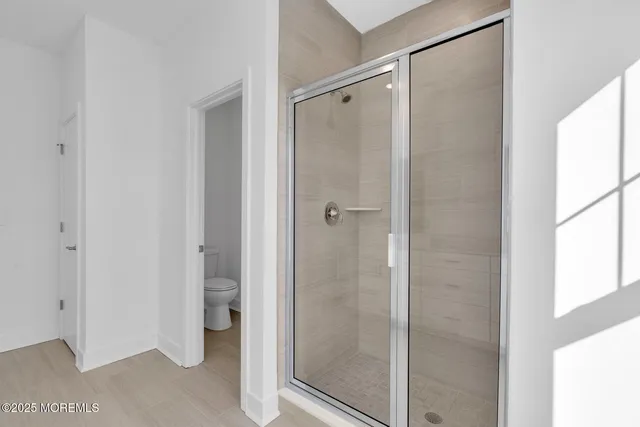 a bathroom with a glass shower door