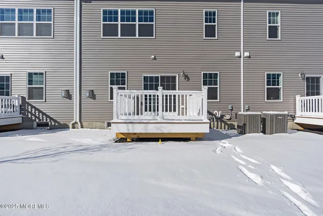 a view of backyard with a chair and wooden fence