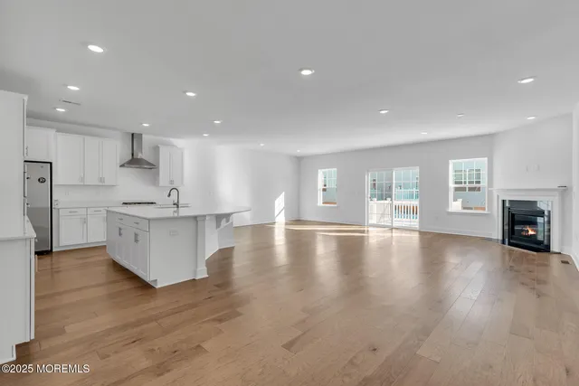 a view of kitchen with kitchen island and stainless steel appliances