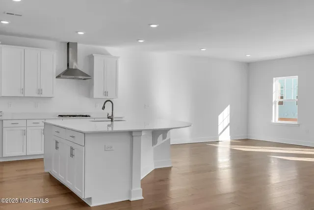 a kitchen with a sink a window and cabinets