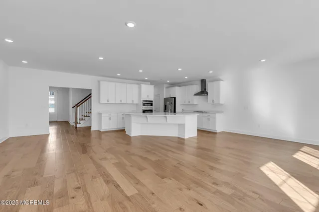 a view of kitchen with kitchen island and stainless steel appliances