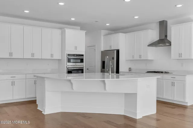 a view of kitchen with stainless steel appliances granite countertop a stove a sink and a refrigerator