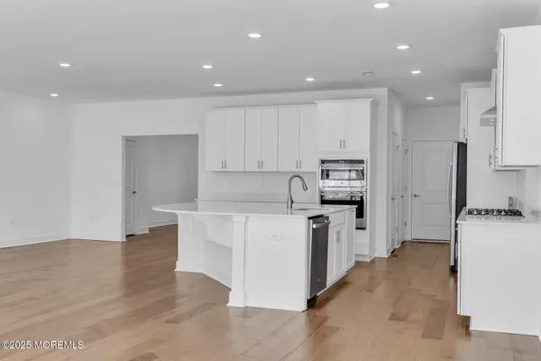 a kitchen with stainless steel appliances a sink stove and cabinets