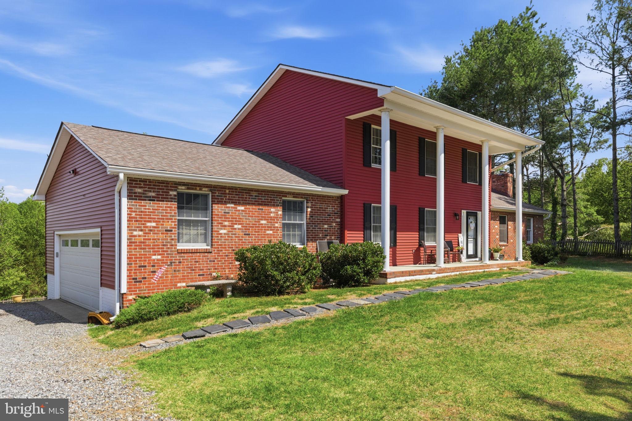 860 Hartwood Road Fredericksburg, VA 22406 - Photo 1 of 24 Charming red brick home with lush greenery.