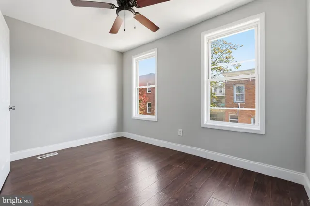 a view of a livingroom with a window and wooden floor