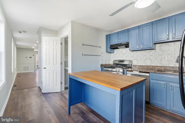a kitchen with wooden cabinets and sink