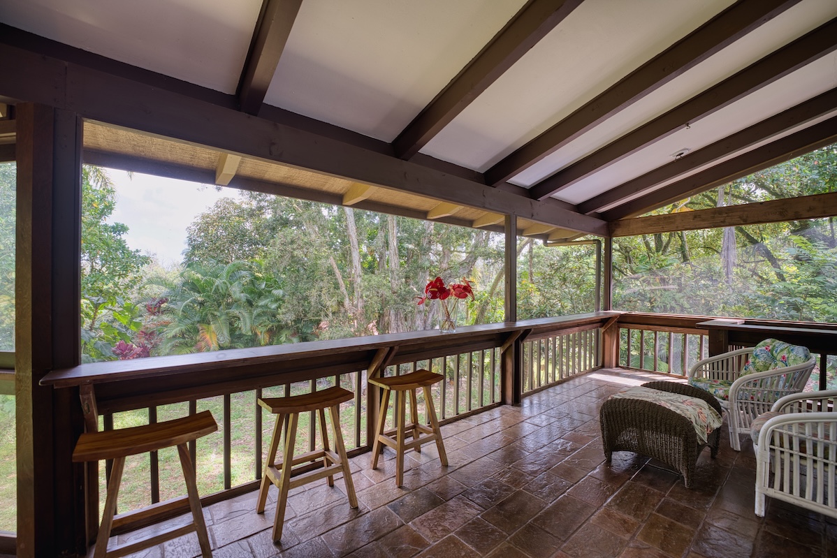 173 Opio Road Hilo, HI 96720 - Photo 12 of 27 a view of a porch with furniture and wooden floor