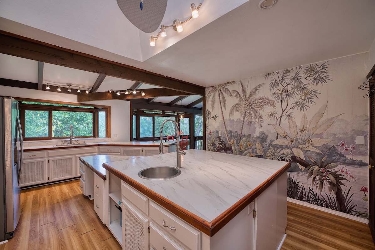 173 Opio Road Hilo, HI 96720 - Photo 13 of 27 a kitchen with sink and wooden floor
