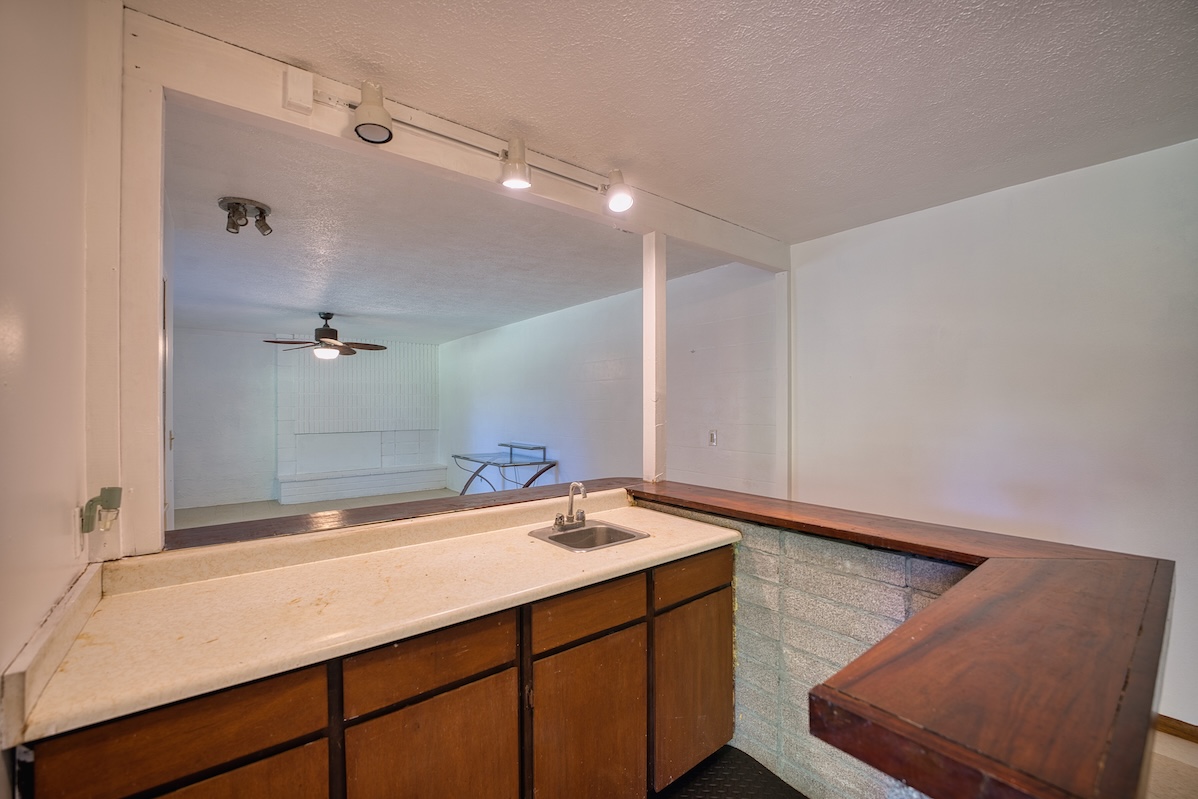 173 Opio Road Hilo, HI 96720 - Photo 24 of 27 a bathroom with a sink and a mirror