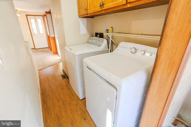 an aerial view of a house with a yard and large trees
