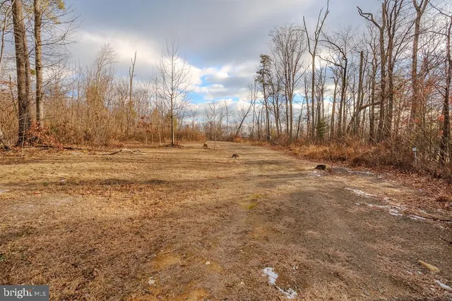 a view of a backyard with table and chairs